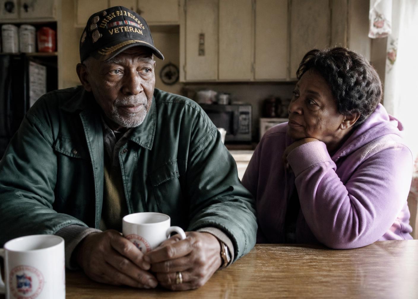 An older veteran and his wife at their kitchen table